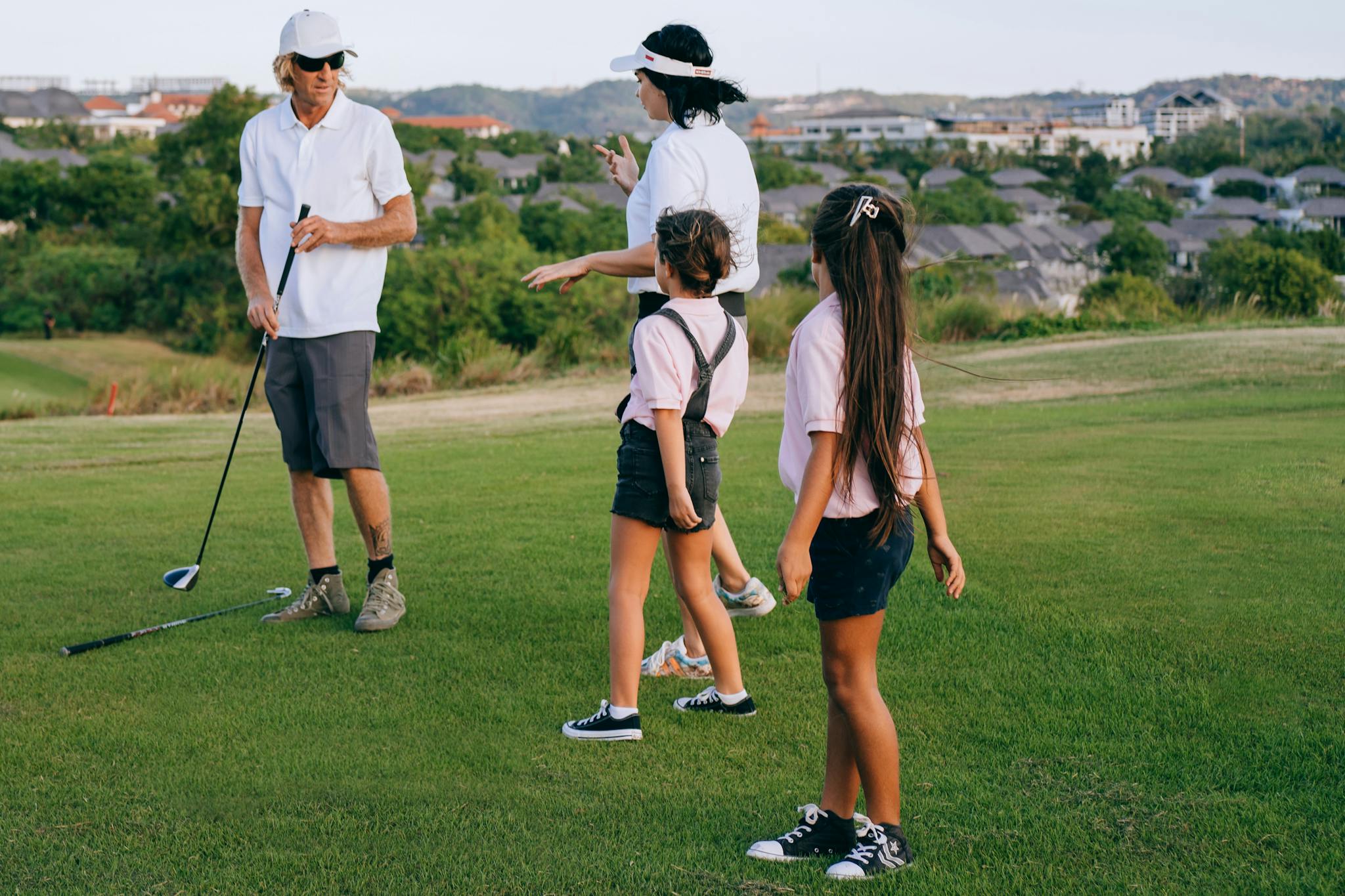 A family spending quality time playing golf together outdoors.